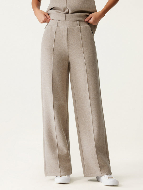 woman in beige straight leg pants