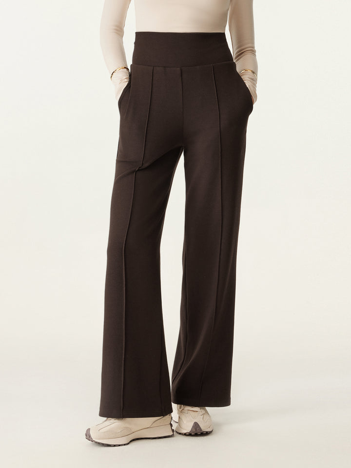 woman in wide waistband pintuck pants